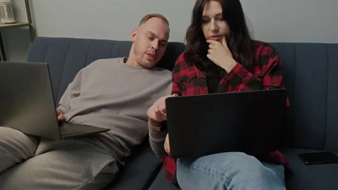 Digital couple works or studies on laptops in cozy home setting. Trendy concept Stock-Footage 283852947