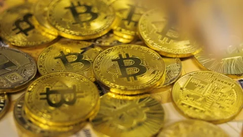 Digital Currency Bitcoins Falls down on Coins Pile Stock Footage 89876351