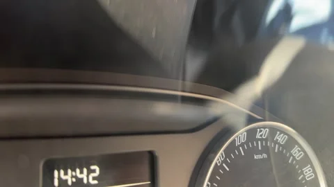 Digital dashboard display shows time and vehicle information during ignition Stock Footage 337115141