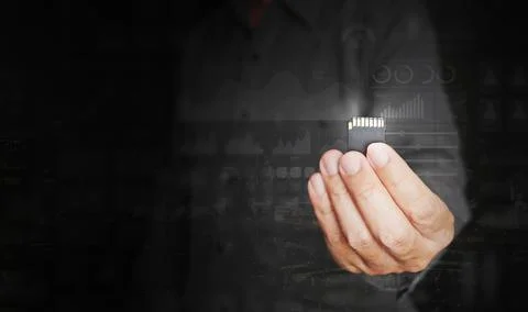 Digital data storage and sharing technology concept. A man holds an SD card.. Stock Photos