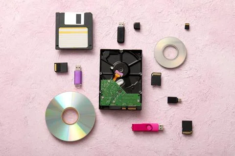 Digital data storage devices flat lay with floppy disk, hard drive, USB drive Stock Photos
