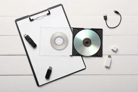 Digital data storage devices with USB flash drives, compact discs, and clipbo Stock Photos