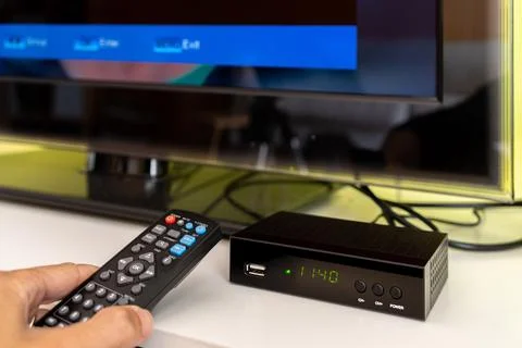 Digital decoder with remote control and television monitor. Stock Photos