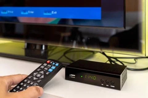 Digital decoder with remote control and television monitor. Digital decode... Stock Photos