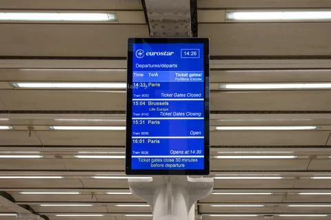 A digital departure board displaying train schedules and platform information Stock Photos