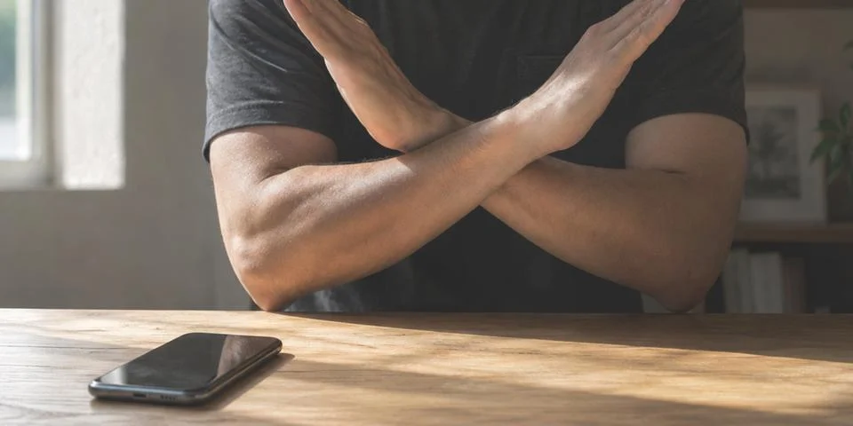 Digital detox concept with Hands refusing smartphones on the wooden table Stock Photos