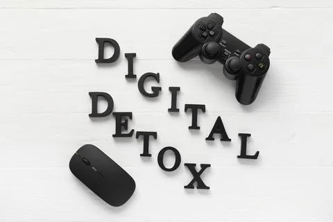 Digital detox with game controller and computer mouse on white wooden backgro Stock Photos