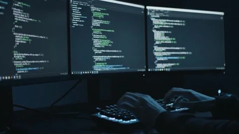 Digital Development: Programmer Typing Code on Multiple Screens Video stock 313246335