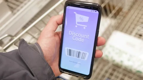Digital Discount Code on a Smartphone While Shopping in a Store Stock Footage 144034979