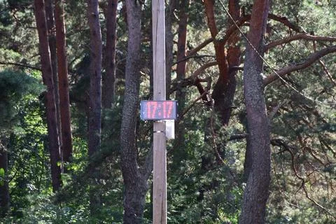 Digital Display Board Showing Time Mounted on Wooden Pole Stock Photos