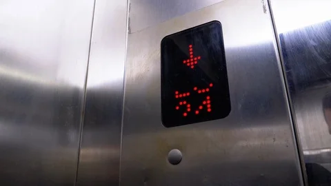 Digital Display in the Elevator with Arrow Down Shows Floors from 24th to the Stock Footage 119371700