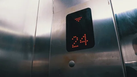 Digital Display in the Elevator with Arrow Down Shows Floors from 24st to 20th Stock Footage 120376149