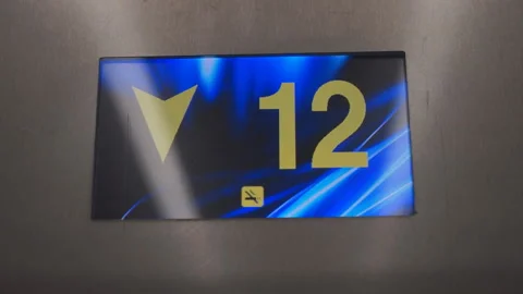 Digital Display in the Elevator with Arrow Down Shows Floors from 20st to 15th Stock Footage 132279513