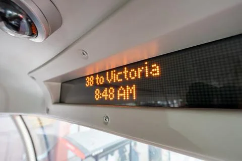 A digital display inside a city bus shows the route 38 to Victoria at 8:48 .. Stock Photos