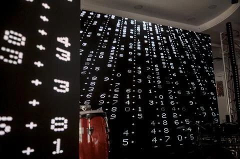 Digital display of mathematical equations and numbers in a performance settin Stock Photos