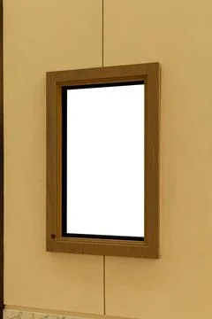A digital display mockup is fixed to a wall in a plain indoor space. The sc.. Stock Photos