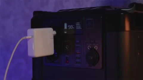 Digital display of portable power station showing voltage and charge Stock Footage 334732362