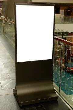 A digital display is positioned in a mall awaiting advertisement content. I.. Stock Photos