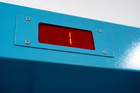 Digital display shows a countdown of one on a bright blue panel mounted on a Stock Photos