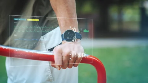 Digital display shows training data of an athletic man doing push-ups on a 動画素材 257462973