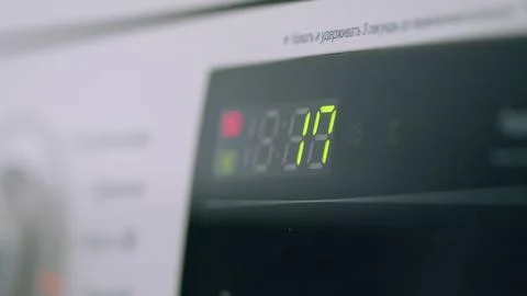 The digital display timer on your washing machine shows the progress of the curr Stock Photos