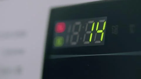 The digital display timer on your washing machine shows the progress of the curr Stock Photos