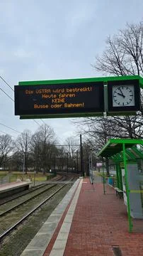 The digital display at the train station features a clock to enhance your travel Foto stock