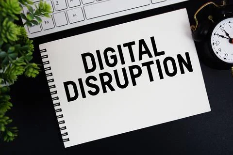 Digital Disruption text written on notepad with keyboard and alarm clock on.. Stock Photos