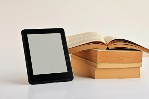 Digital e-book reader with a blank screen on white with books Stock Photos