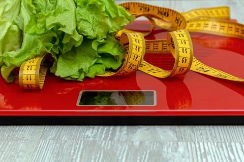 Digital electronic scale with measuring tape, lettuce. diet, slimming concept Stock Photos