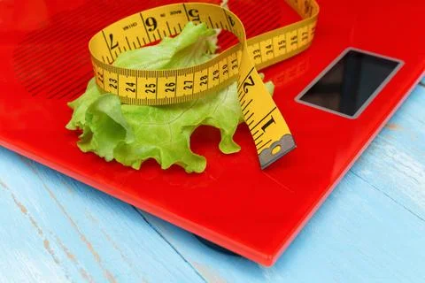 Digital electronic scale with measuring tape, lettuce. diet, slimming concept Stock Photos