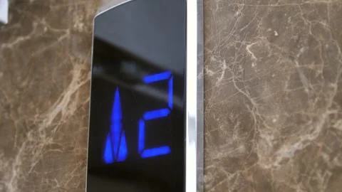 Digital elevator display showing floor number - elevator going up in a shopping Stock Footage 260971889