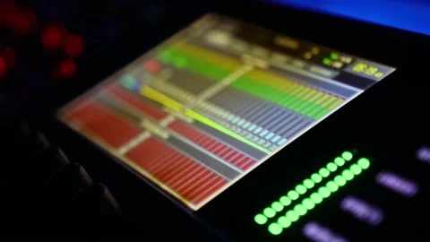 Digital equalizer on screen and audio signal level indicators on mixing console Stock Footage 231378013