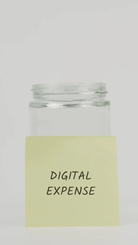 Digital expense text or word on yellow sticky note attached to glass jar Stock Footage 311715674