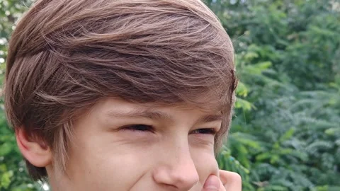 Digital eye strain. Close-up. portrait of a young boy, his eyes squinting with f Stock Footage 319907428
