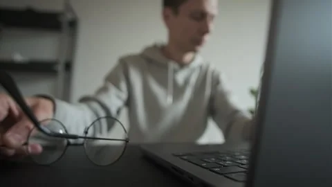 Digital eye strain. Tired overworked man feeling eye strain after using computer Stock Footage 309926058