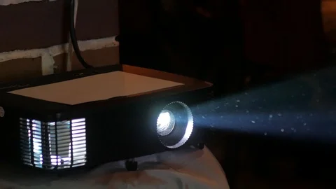 Digital film projector in the work projecting a beam of light in a dark room. Stock Footage 124700808