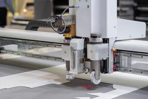 Digital flatbed cutter, plotter cutting white cardboard sheet at exhibition Fotos de archivo