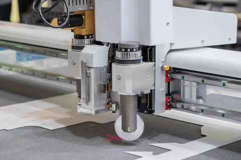Digital flatbed cutter, plotter cutting white cardboard sheet at exhibition Stock Photos