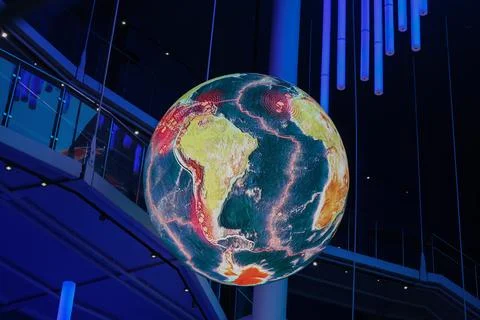 A digital globe displays Earth with tectonic plates and seismic activity Stock Photos