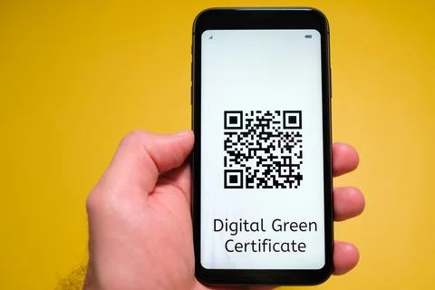 Digital Green Certificate with QR code on the screen of mobile phone in mans Stock Photos