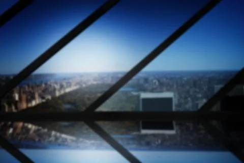 Digital image of city against blue sky seen through metal grate Ilustración de archivo