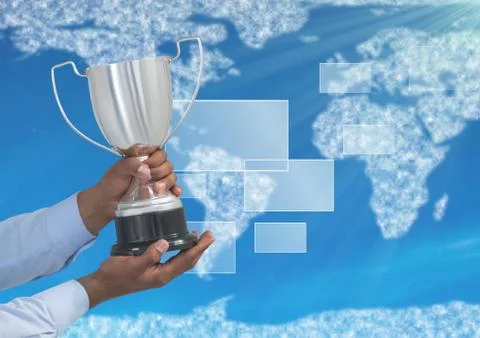 Digital image of hands holding trophy against world map 写真素材