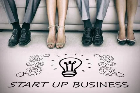 Digital image of light bulb amidst gears over start up business text against  Stock Photos