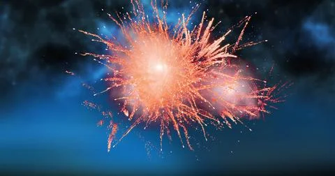 Digital image of red fireworks exploding in the dark sky with clouds 库存照片