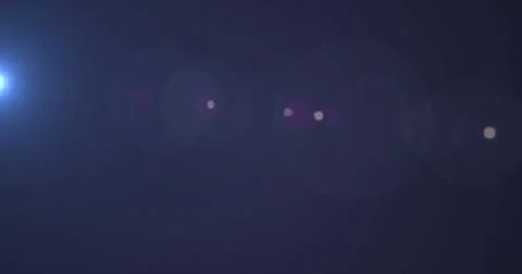 Digital image of spot of light moving against copy space on blue background 스톡 사진