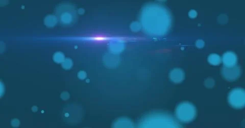 Digital image of spots of light and blue light trail against blue background Stock Photos