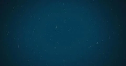 Digital image of white particles falling against blue background Stock Illustration