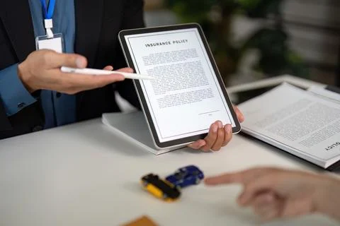 Digital Insurance Policy Presentation. Agent showing policy on tablet. Stock Photos