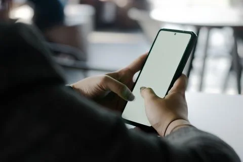 Digital interaction: Hands holding smartphone with blank display indoors Stock Photos